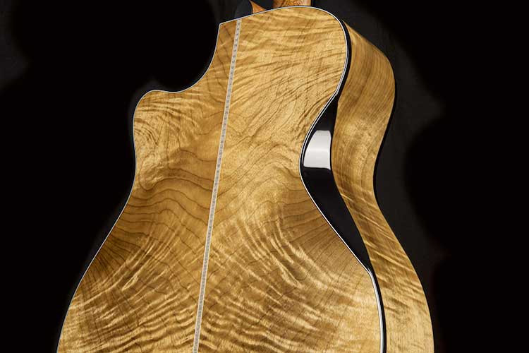closeup of the Cort Gold-Edge acoustic-electric guitar's flamed myrtlewood back and sides and triple bevel cut