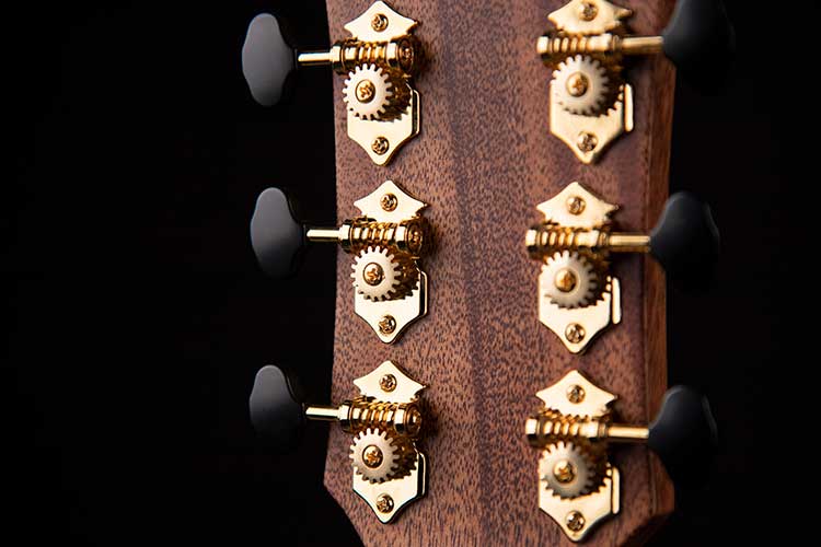 Closeup rear view of the Cort Gold-Edge acoustic-electric guitar's headstock and Gover Vintage tuners