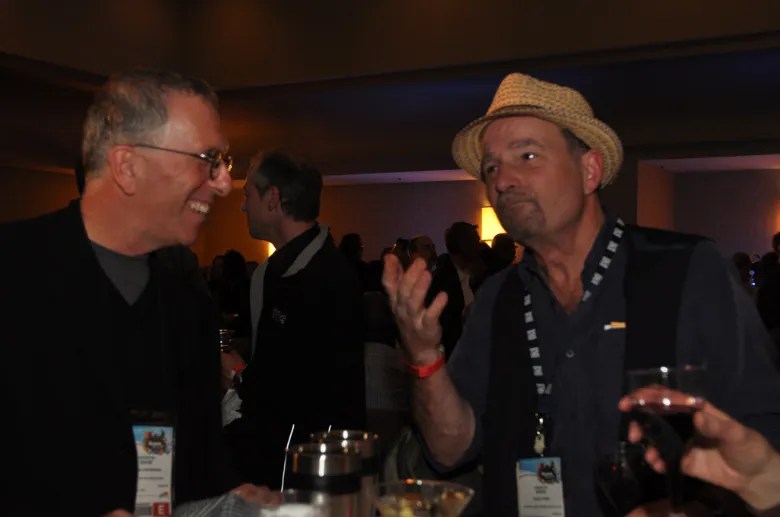 David and Steve laughing over drinks at a NAMM Show party in 2010